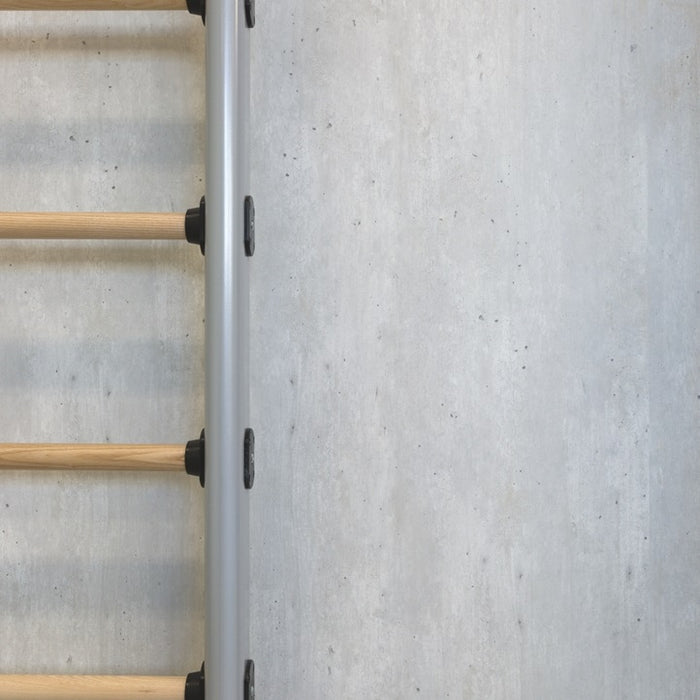 Metal and wooden ladder against a textured white wall