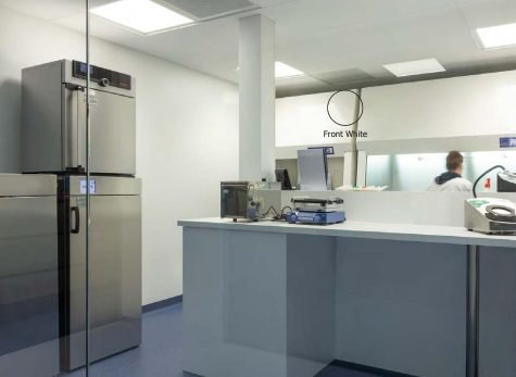 Modern kitchen with stainless steel refrigerator and countertop appliances.