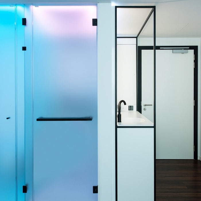 Modern bathroom with glass shower enclosure and white vanity