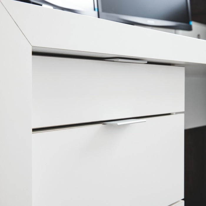 Close-up of a white drawer with metallic handle on a white cabinet.