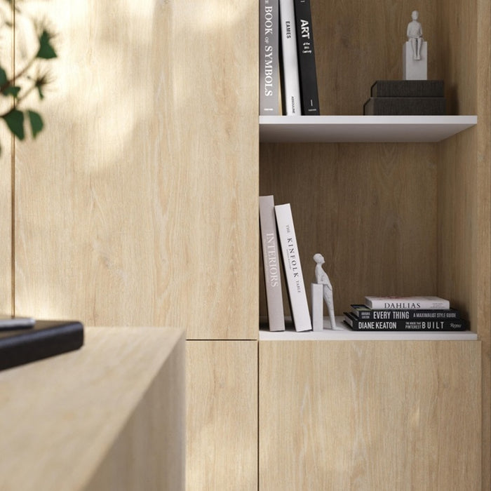 Wooden bookshelf with books and decor items against a wooden wall.