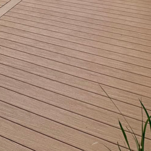 Close-up of wooden deck with grass in the corner